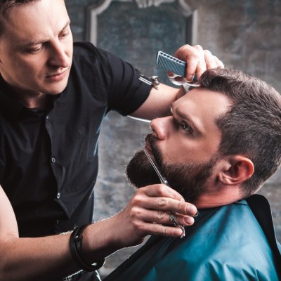Barber who is trimming a moustache