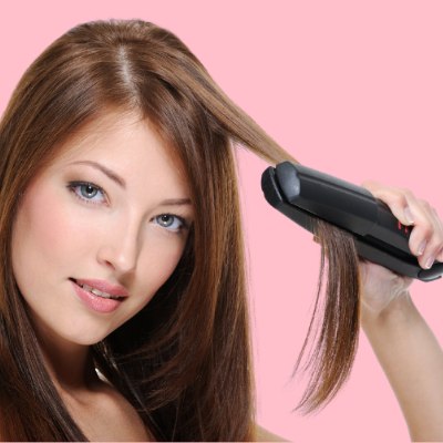 Woman using a flat iron