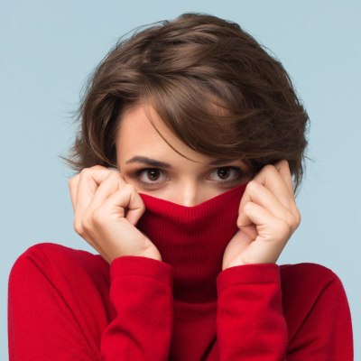 Woman hiding her facial features in her turtleneck