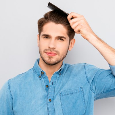 Man who is combing his hair