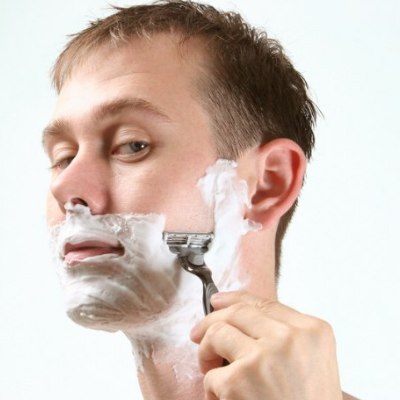 Man who is shaving his face