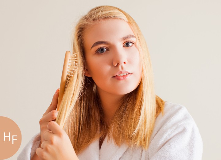 Woman taking care of her damaged long bleached hair