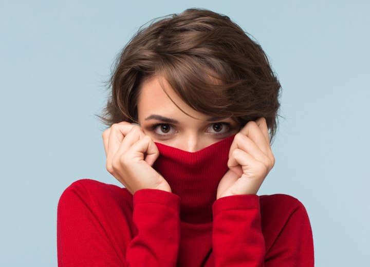 Woman hiding her face in a turtleneck