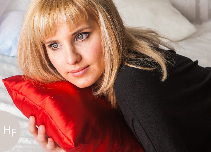 Blonde woman with a silk or satin pillow