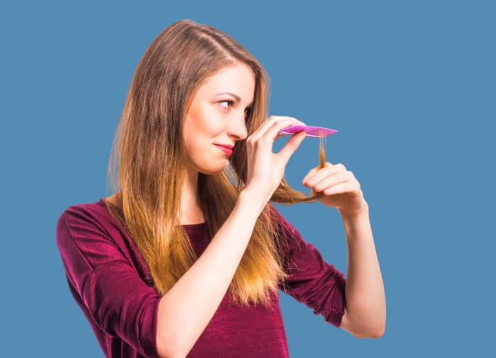 Girl checking her hair for split ends