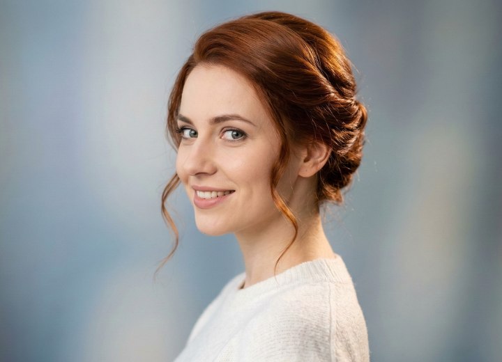 Hair, styled in a twist with loose tendrils