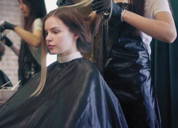 Girl who is wearing a hair cutting cape