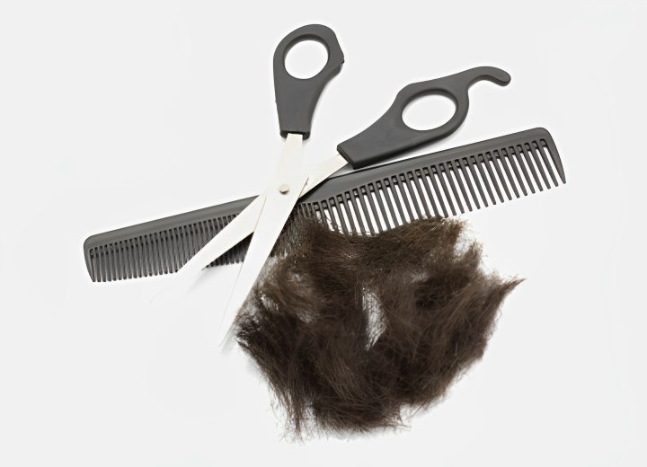 Comb, scissors and freshly cut hair