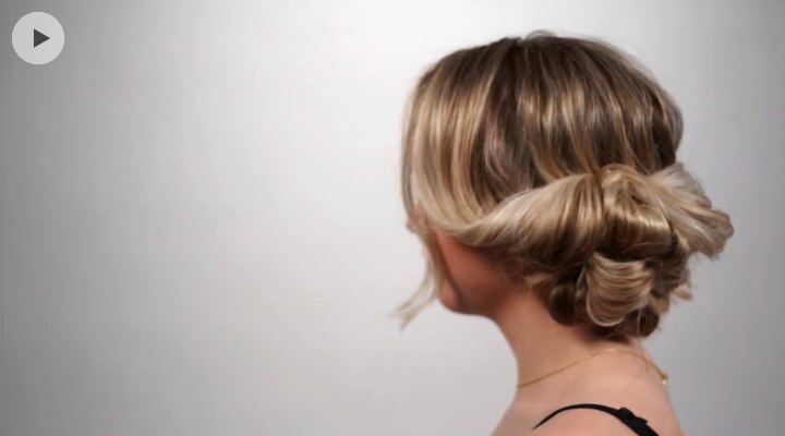 Hair styled into a bubble updo on the side