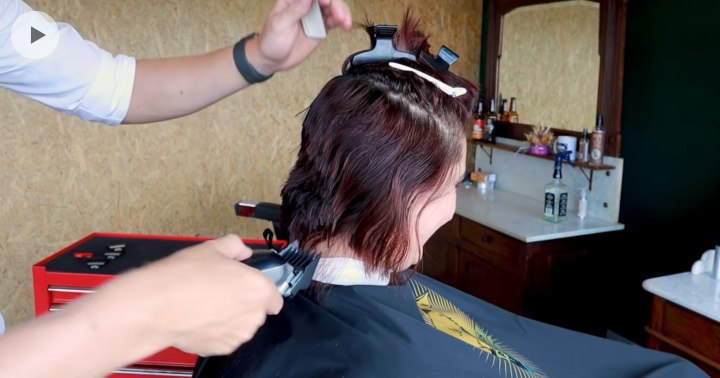 Women's hair being cut with clippers