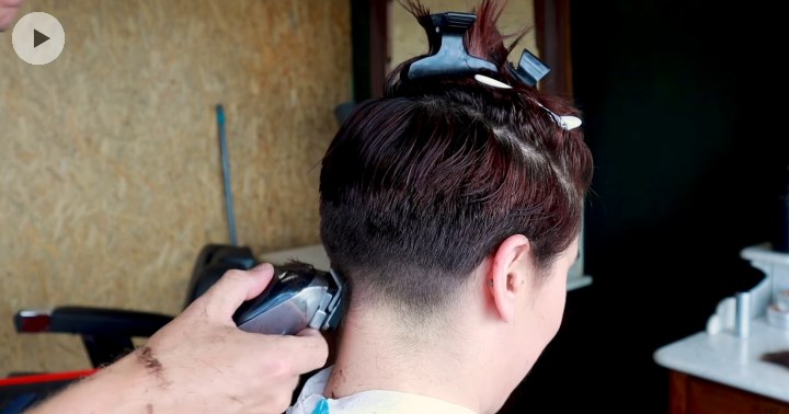 Buzzing the neck of a woman with clippers